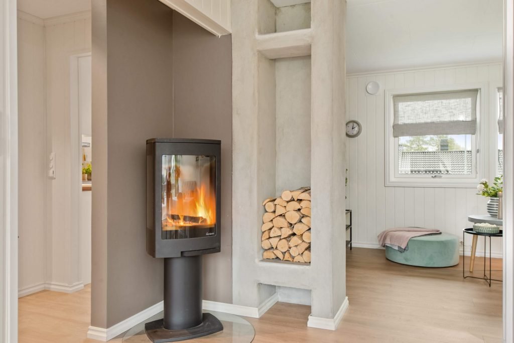 living room with logs by fireplace